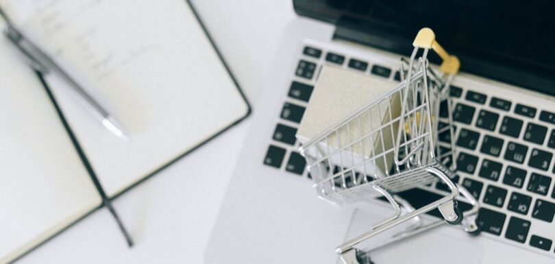 Laptop with a miniature shopping trolley representing selling cosmetics online in the EU