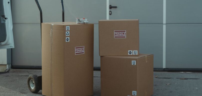 Stacked cardboard parcels with shipping labels ready for marketplace dispatch
