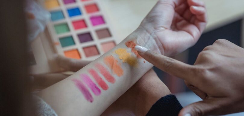 Range of foundation shades and make-up pigments swatched on a neutral surface