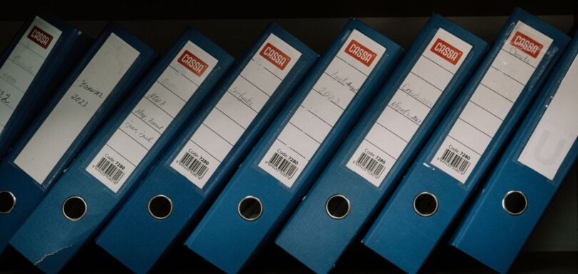 Row of blue archive binders holding technical product documentation