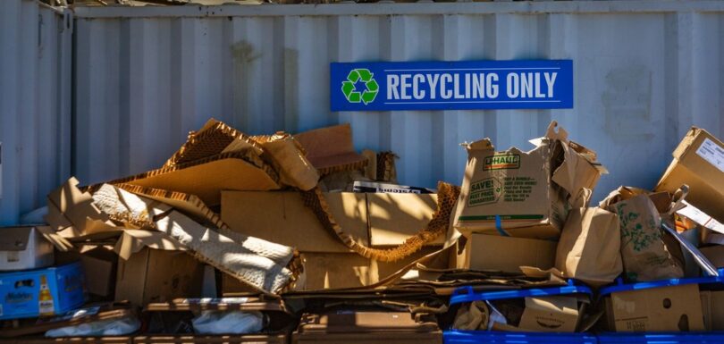 Recycling-only signage above sorted cardboard packaging waste
