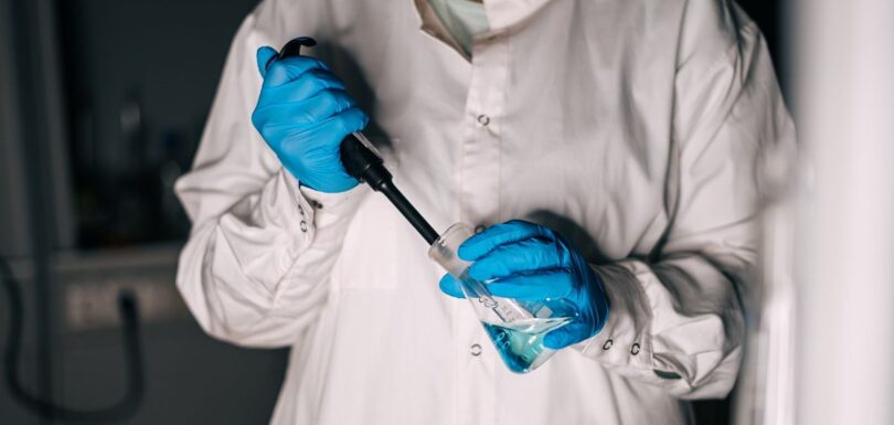 Laboratory technician using a pipette during cosmetic product testing
