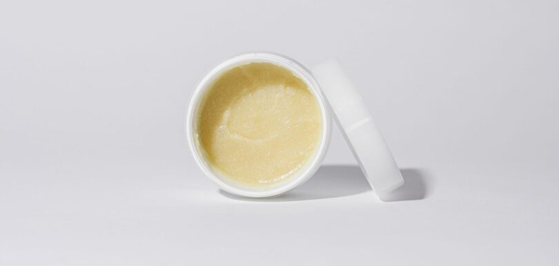 Body lotion and body oil containers on a neutral background