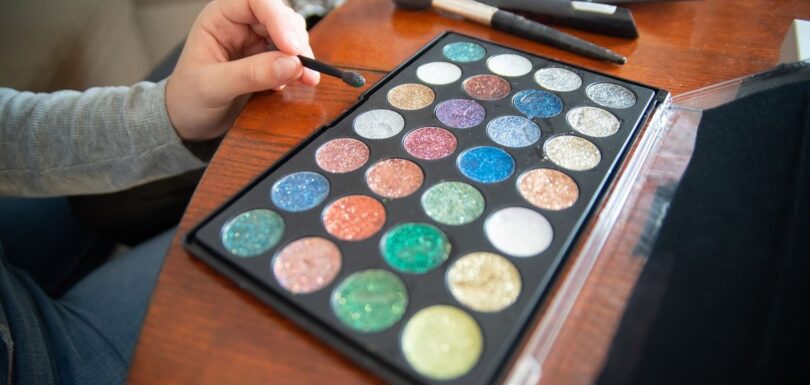 An open eyeshadow palette showing a range of pressed powder shades