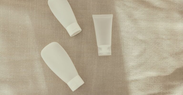 A range of unbranded cosmetic products arranged on a neutral surface