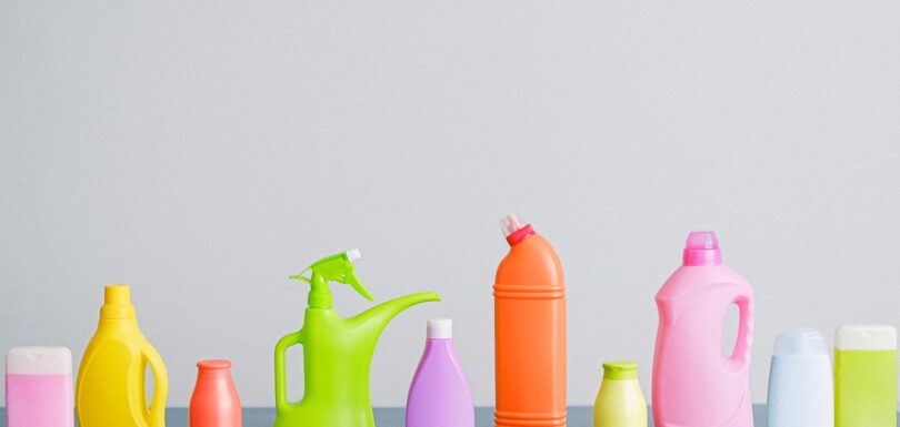 Colourful plastic cleaning product bottles in a row
